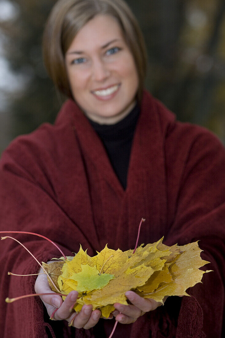 Woman with maple leaves