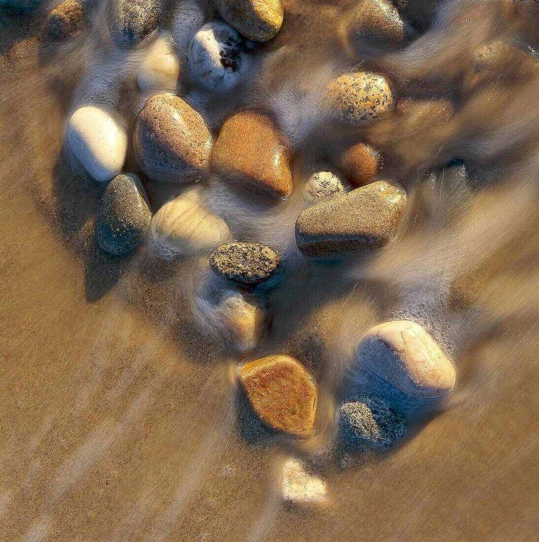 Small stones in water´s edge