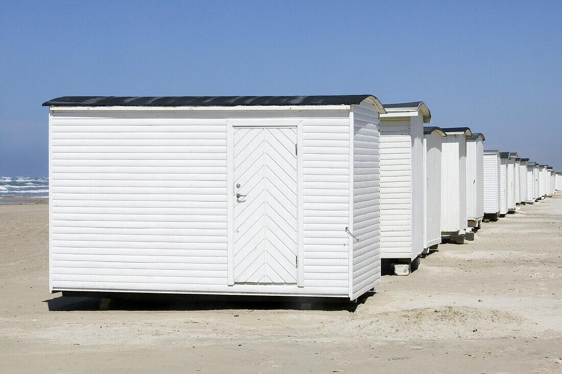 White bathing huts on the beach, Jutland, Denmark