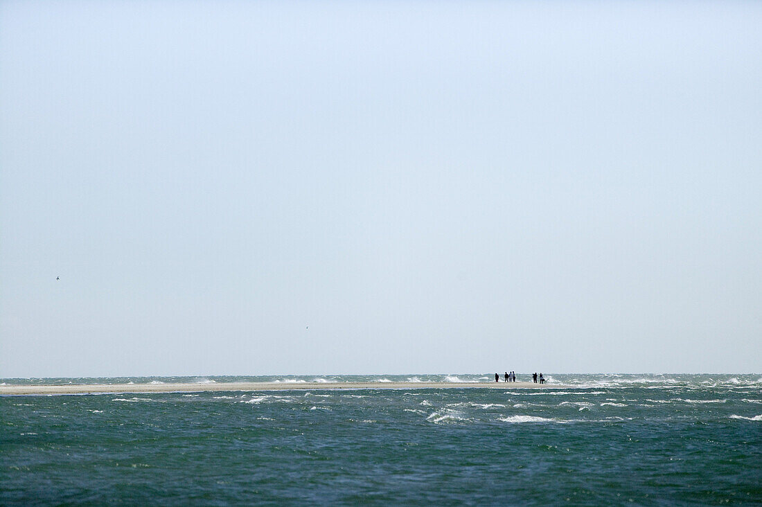 People are walking on beach, the farthest headland where Skagerrak and the Kattegatt meet, Skagen, Jutland, Denmark