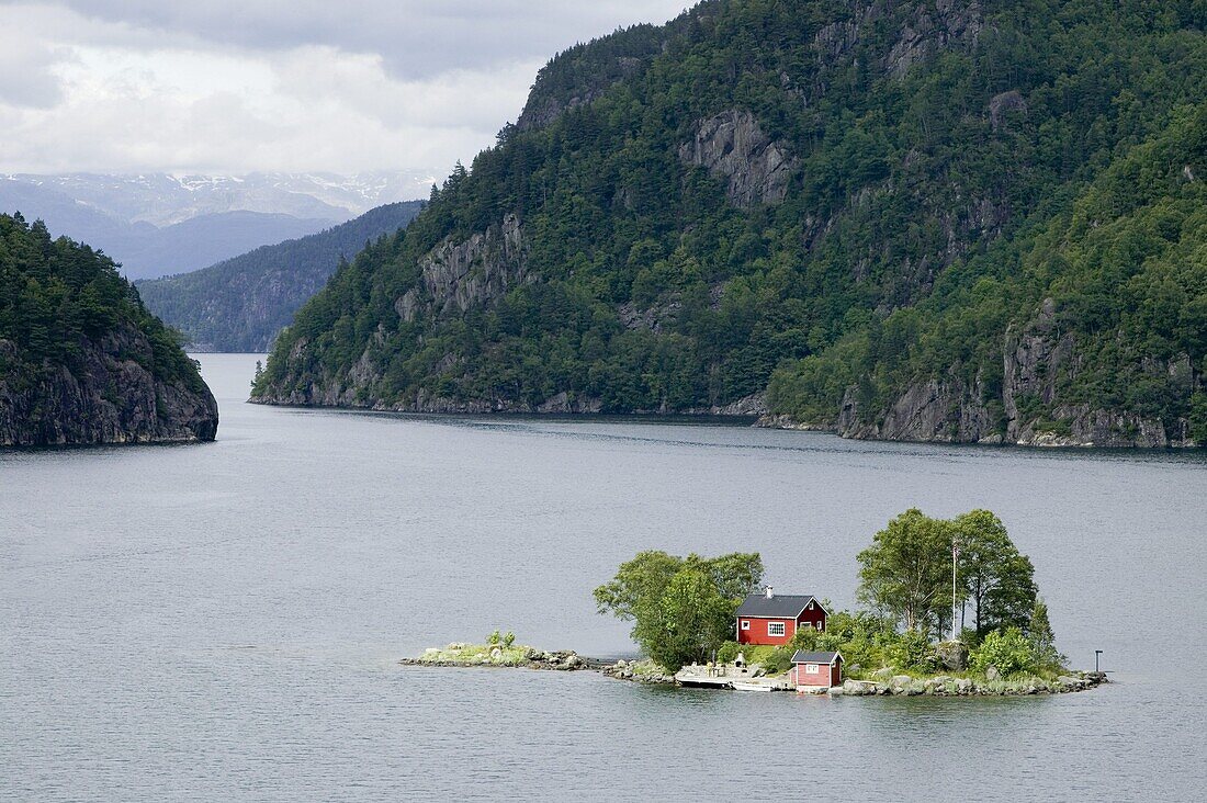 Small red cottage on a tiny island, Norway