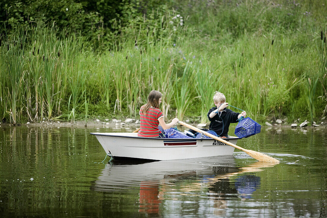 Boy and girl fishing for crayfish (MR)