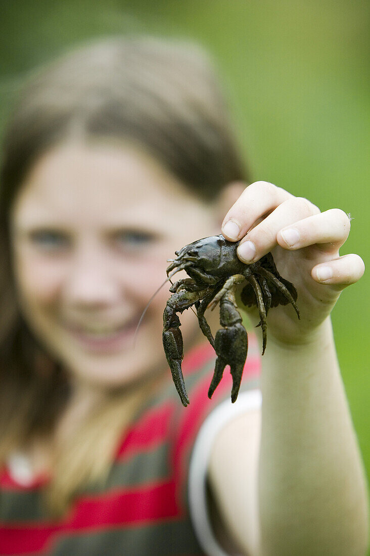 Girl holding crayfish (MR)