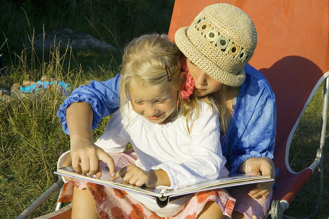 Girl is reading for a younger girl