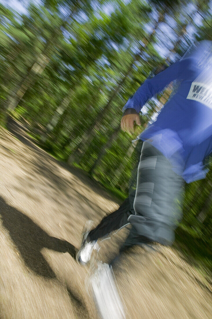 Man runs in Kronoskogen, angelholm, on a fitness path, Skane, Sweden