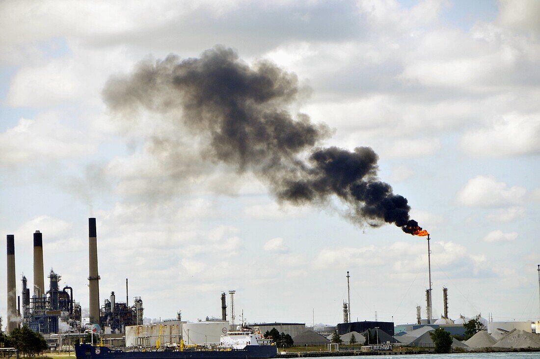 Factory smokestacks along St  Clair River Michigan USA create air pollution