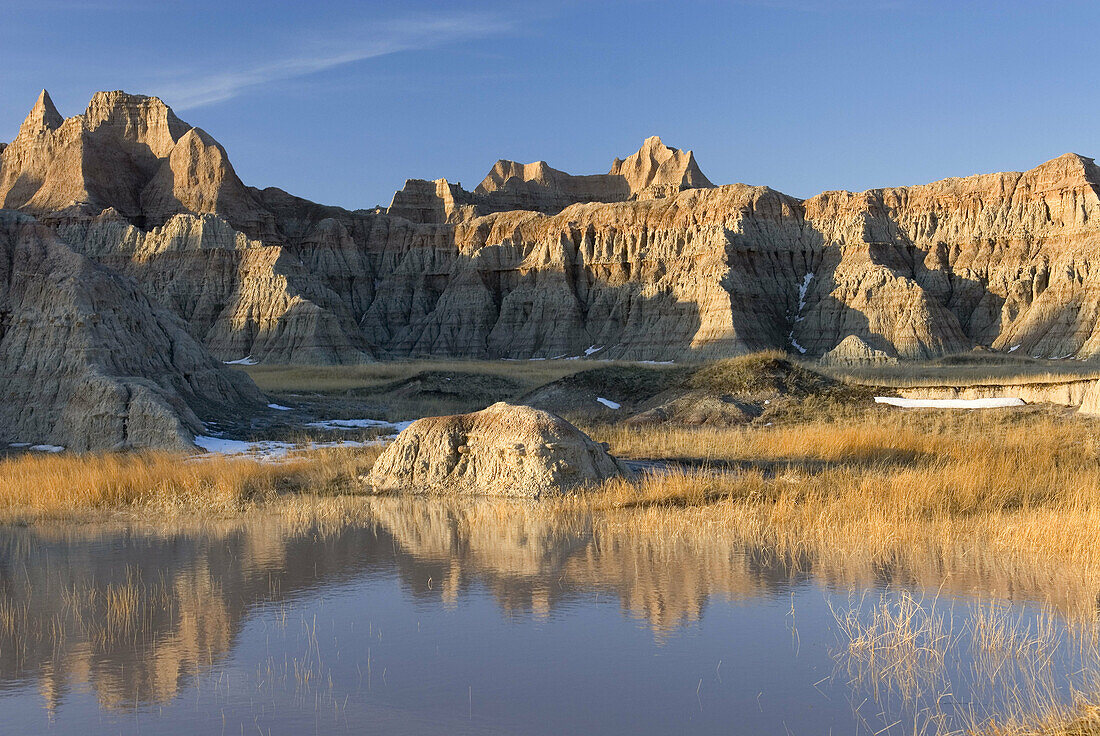 Badlands hoodoos reflected in seasonal pools, Badlands National Park South Dakota USA