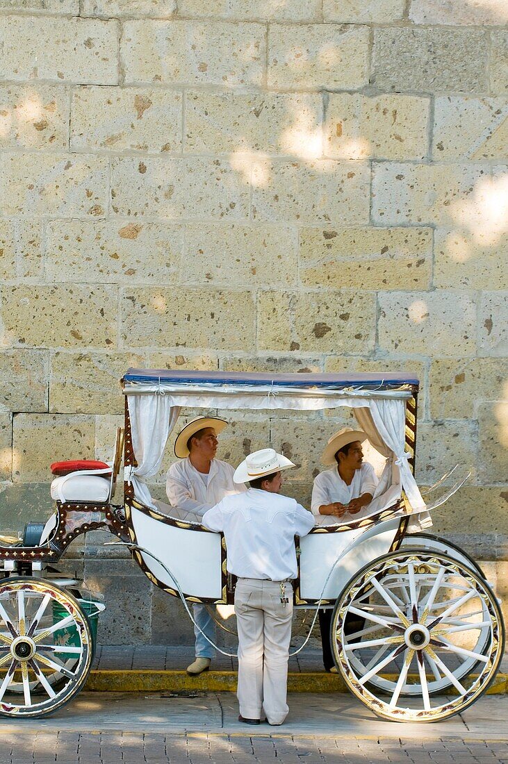 Calandrias horse drawn carriages and their drivers, on Avenida Corona in the historic Center of Guadalajara, Jalisco, Mexico