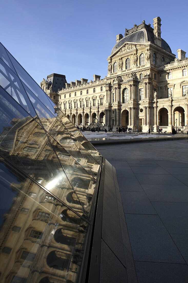 Glass pyramid with Richelieu Wing of Musee du Louvre in background, Paris. France