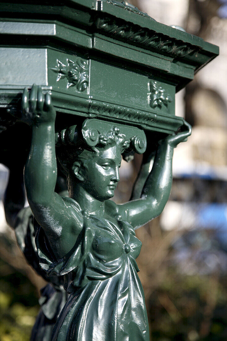 A closed up view of a figure on a drinking fountain in Montmartre, Paris. France