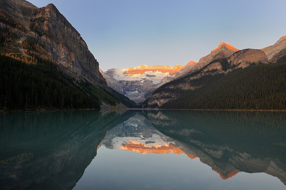 Sunrise and moutains reflecting in Lake Louise, Banff National Park, Rocky Mountains, Alberta, Canada