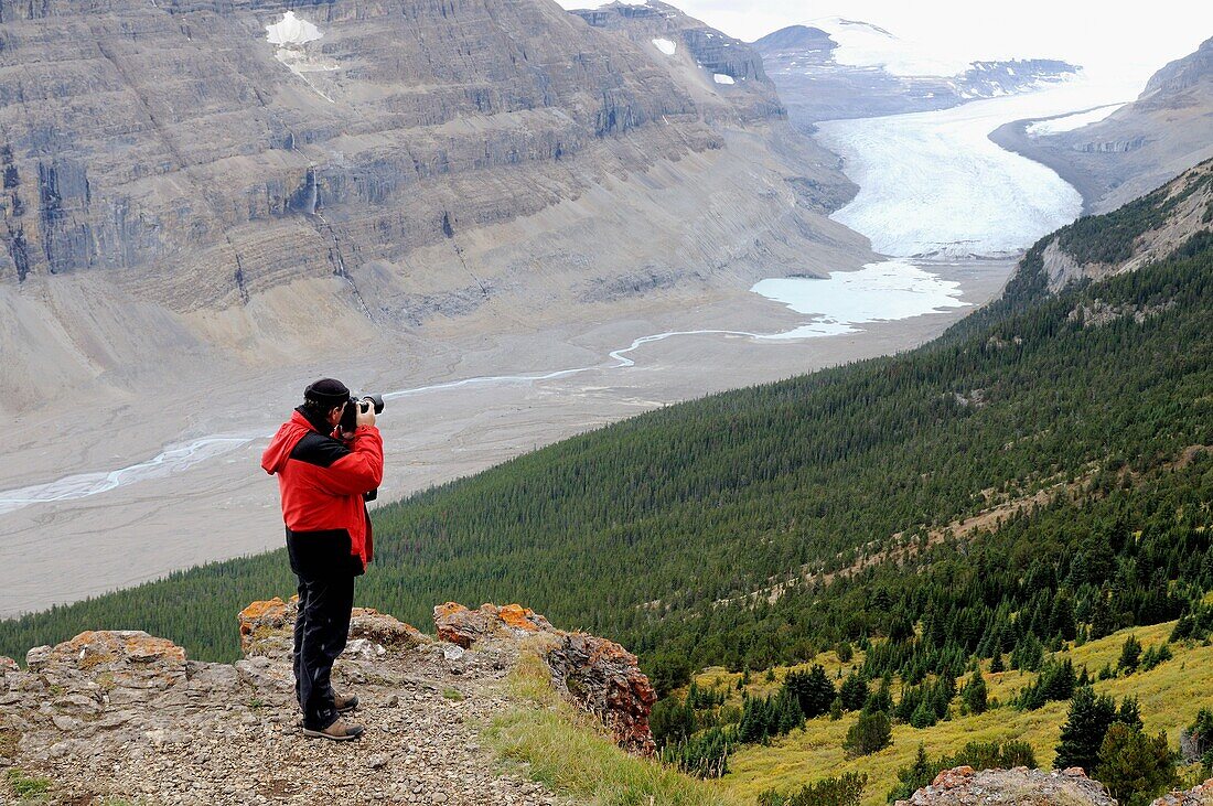 Photographer Eric Baccega taking picture of Saskatchewan Glacier  Columbia Icefield, Jasper National Park, Rocky Mountains, Alberta, Canada