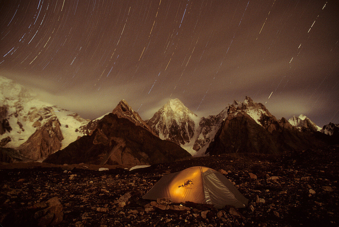 Tent and Star trail over 7000 TO 8000 meter Broad and Masherbrum in Hushe Peaks area of Karakoram Himalaya