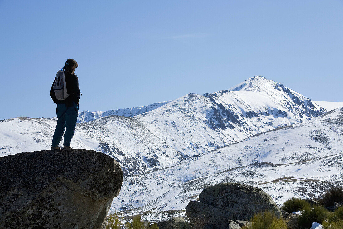 Mountaineer watching the snowy slopes in the Sierra de Barco  Sierra de Gredos Regional Park  Aravalle Valley  Barco de Avila  Avila  Castilla y Leon  Spain