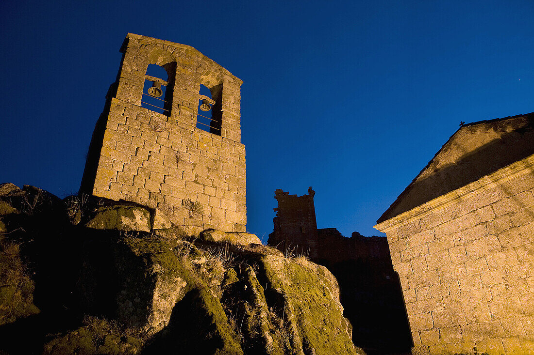 Night view of the San Juan Bautista Chuch wit the Trevejo Castle behind  Trevejo  Villamiel  Sierra de Gata  Caceres province  Extremadura  Spain