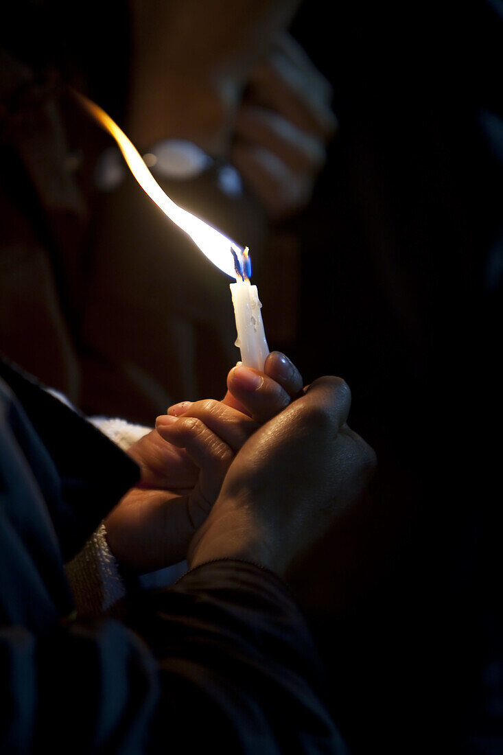 Hand holding candle