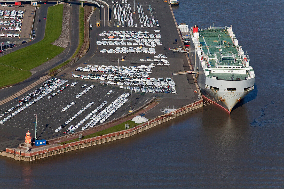 Aerial shot pier with cargo ship, new cars for loading, Emden, Lower Saxony, Germany