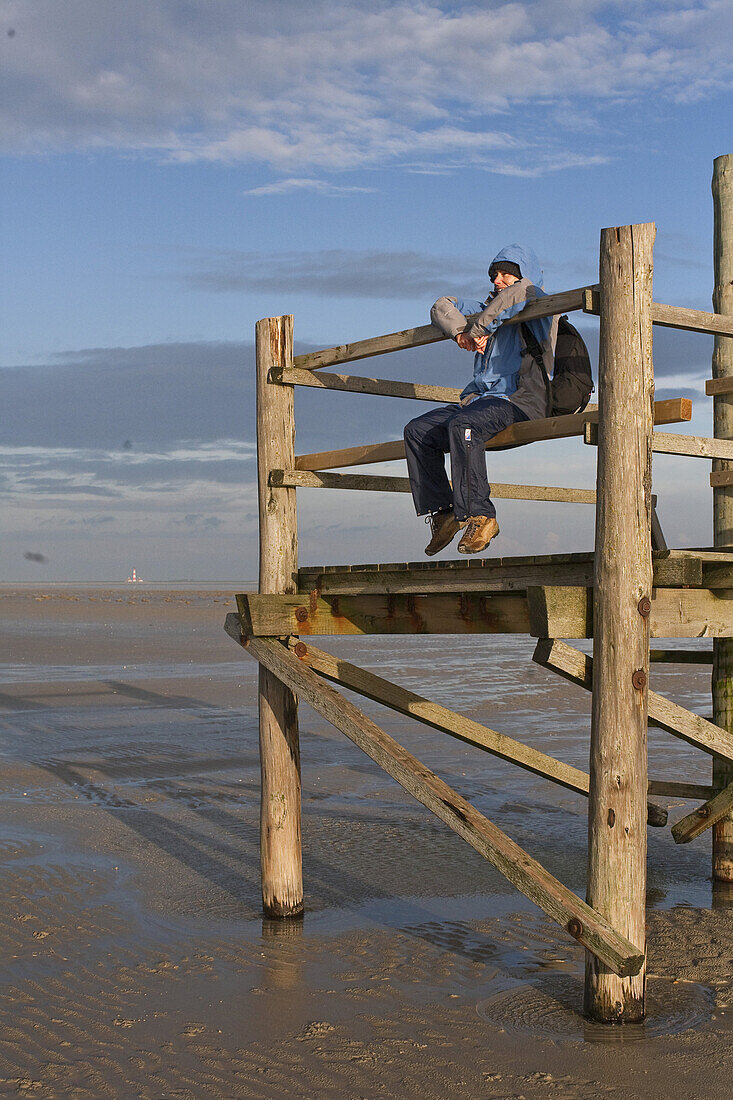Person on an observation platform at low tide, St Peter-Ording, North Sea, Schleswig-Holstein, northern Germany