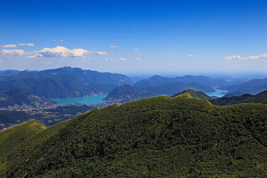 View from the mountain top of Monte Tamaro to Lugano and the Lago di Lugano, hike in the mountains to Monte Tamaro, Ticino, Switzerland