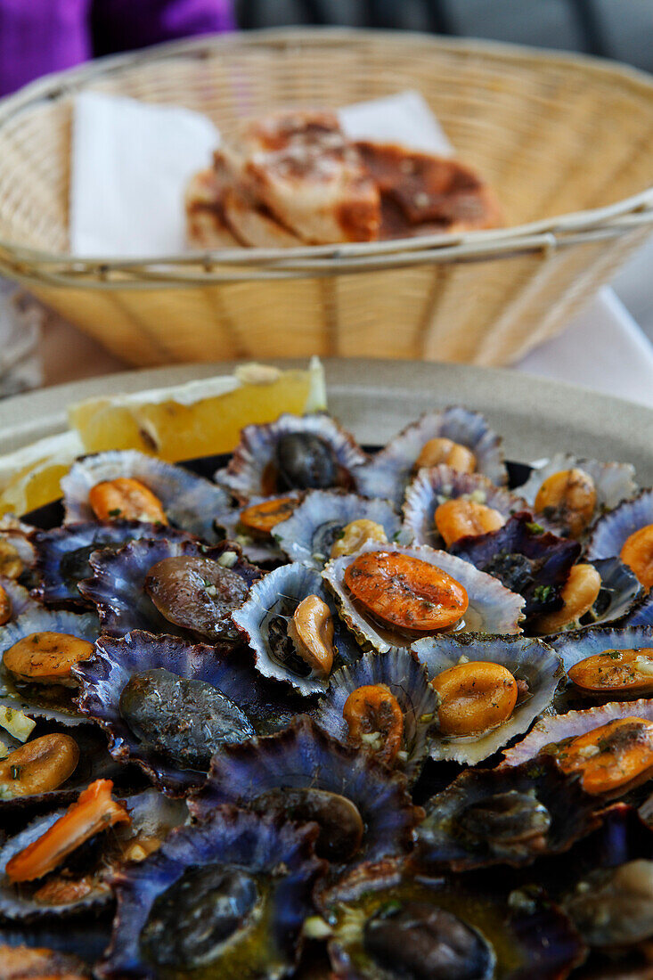 A plate of mussels, Lapas in a restaurant in Funchal, Madeira, Portugal