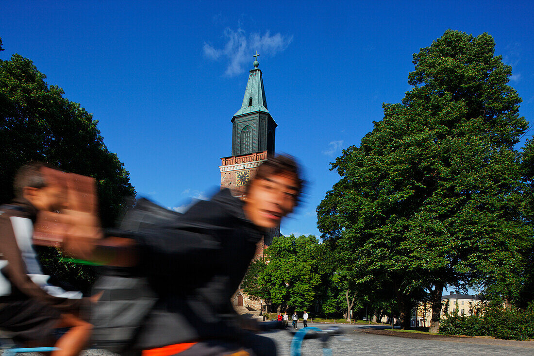 Young man on his bicycle on the cathedral square, Turku, Finland
