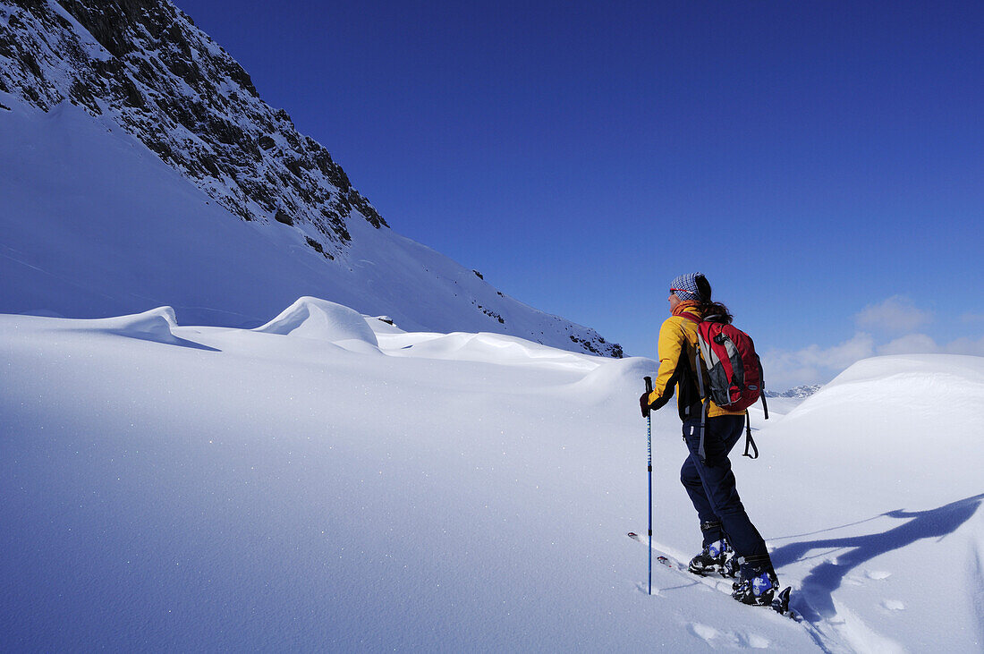 Woman backcountry skiing, Hohe Warte, Schmirntal valley, Tuxer Alpen range, Tyrol, Austria