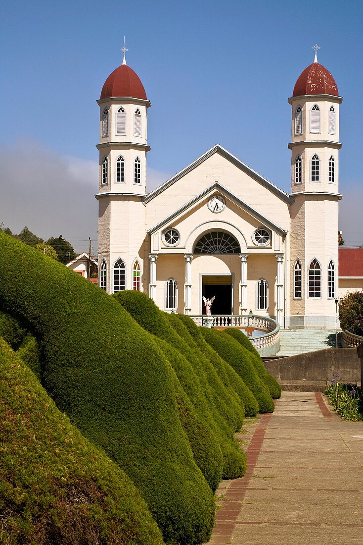 Iglesia de San Rafael behind a tunnel of arches created in the bushes by Evangelisto Blanco in Zarcero, Costa Rica