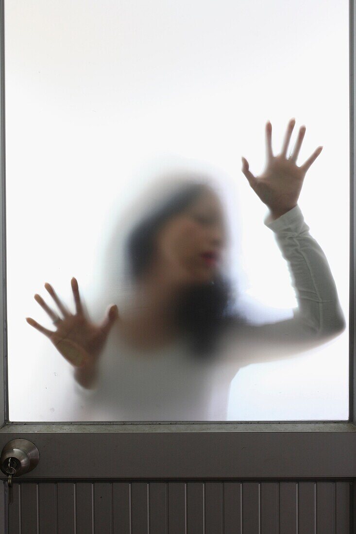 Woman behind a frosted glass door