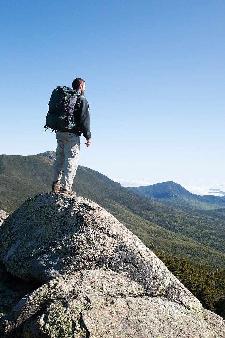 A hiker enjoys the views of the Pemigewasset Wilderness from the summit of Mount Liberty during the summer months  Located in the White Mountains, New Hampshire USA