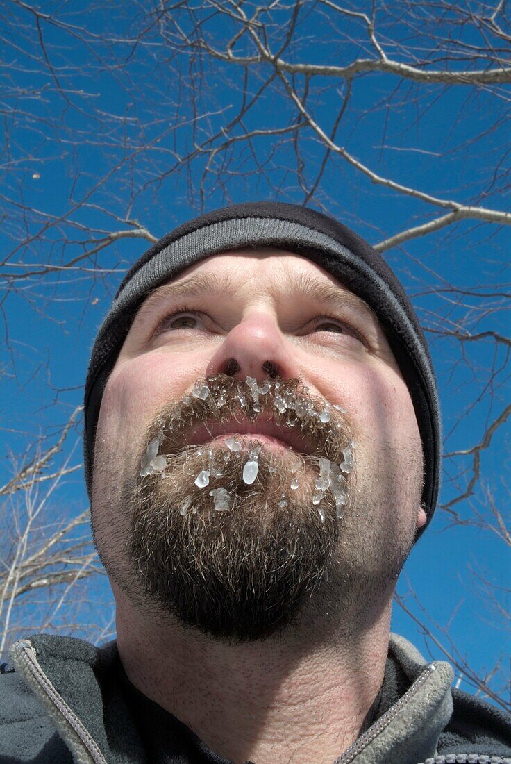 Close-up of a hiker´s beard covered with ice on the side of a hiking trail in the White Mountain National Forest, New Hampshire USA  Note: Weather temp near zero