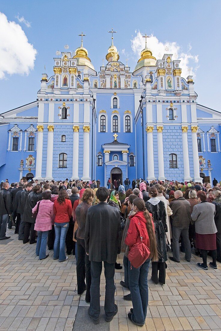 Parishoners stand infront of St Micheals Cathedral of the Golden Domes and monastery Kiev Ukraine