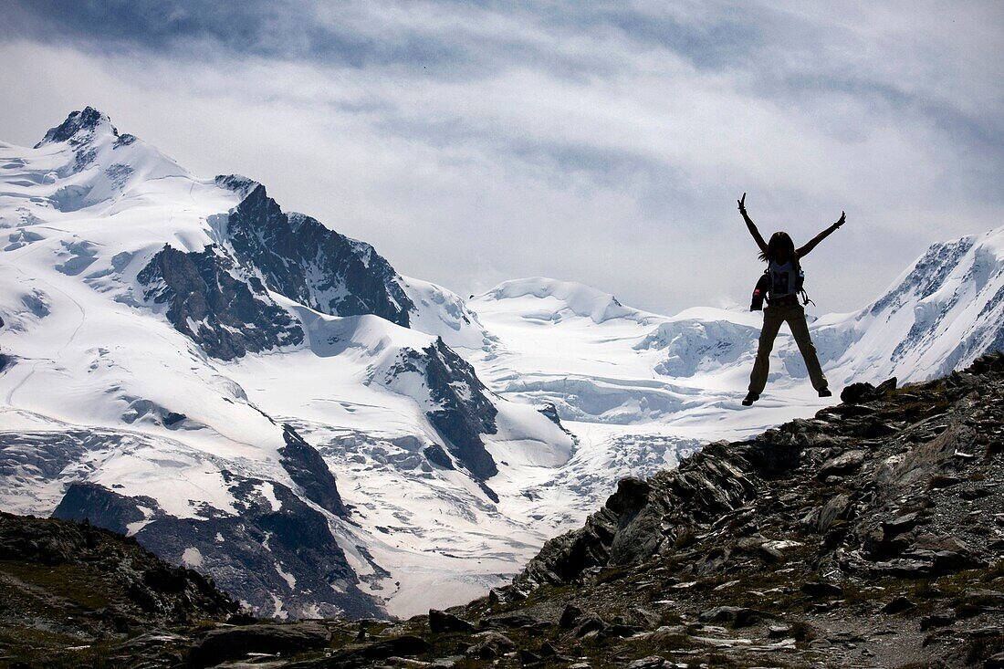 Young woman jumping in Gornetgrat glacier  Switzerland