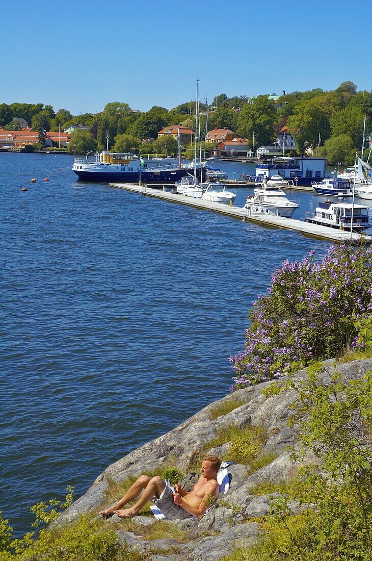 A man relaxing near Prins Eugens Waldemarsudde museum in Djurgården island in Stockholm Sweden EU