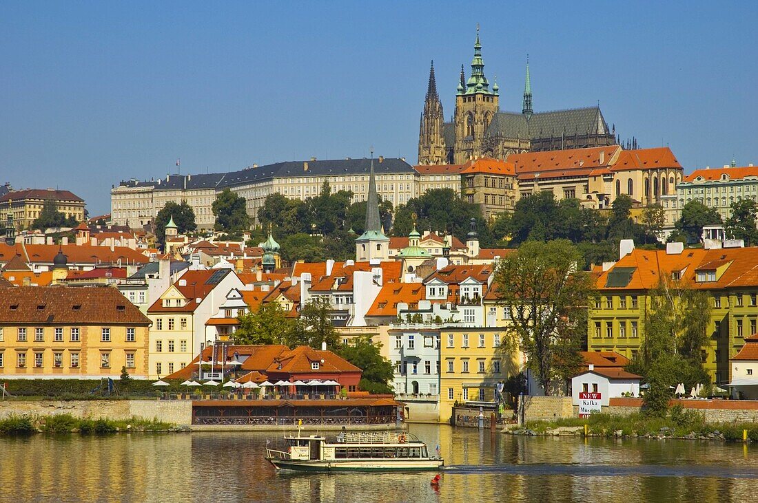 Sightseeing boat in front of Hrad the Prague castle and Mala Strana district in central Prague Czech Republic EU