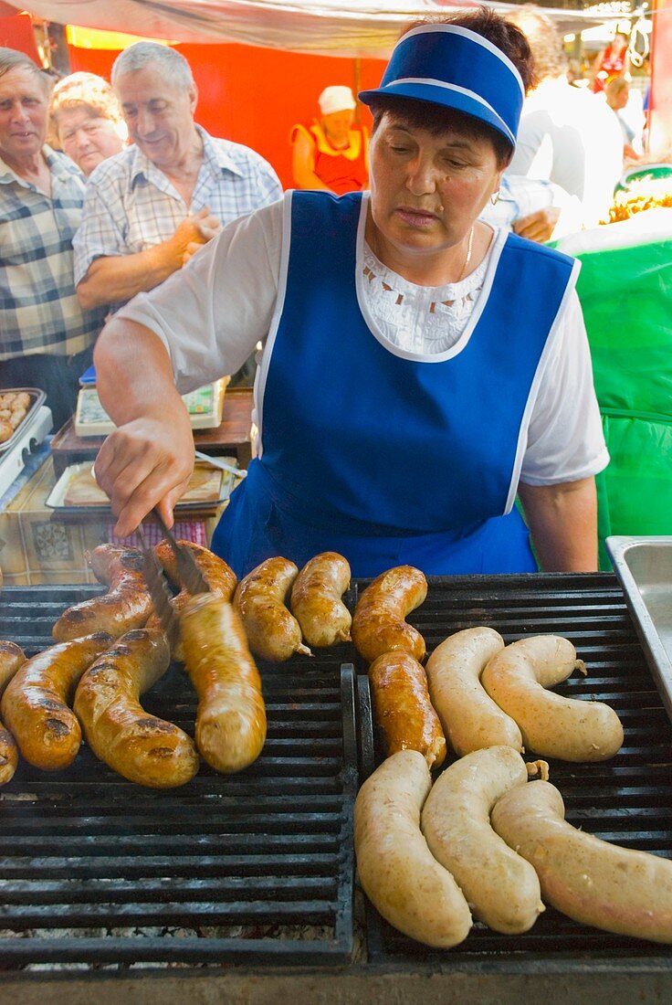 Grilling sausages at Pieta Centrala marketplace in Chisinau Moldova Europe
