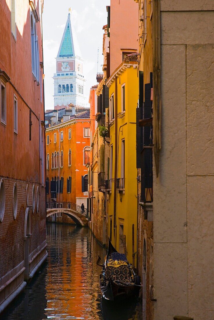 Small canal with Campanile bell tower in the background in Venice Italy Europe