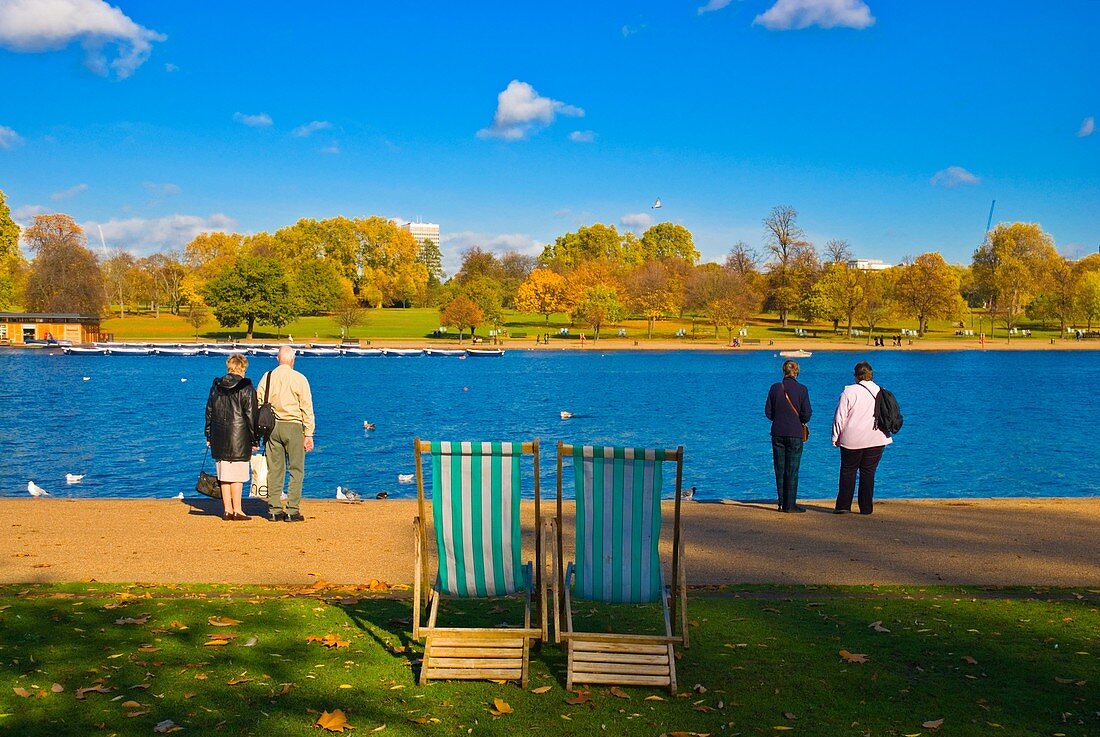 People at the Serpentine lake Kensington Gardens central London England UK Europe