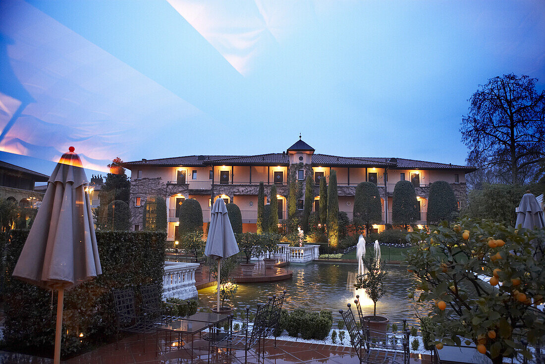 View into the yard and cafe in the evening, Hotel Giardino, Ascona, Ticino, Switzerland