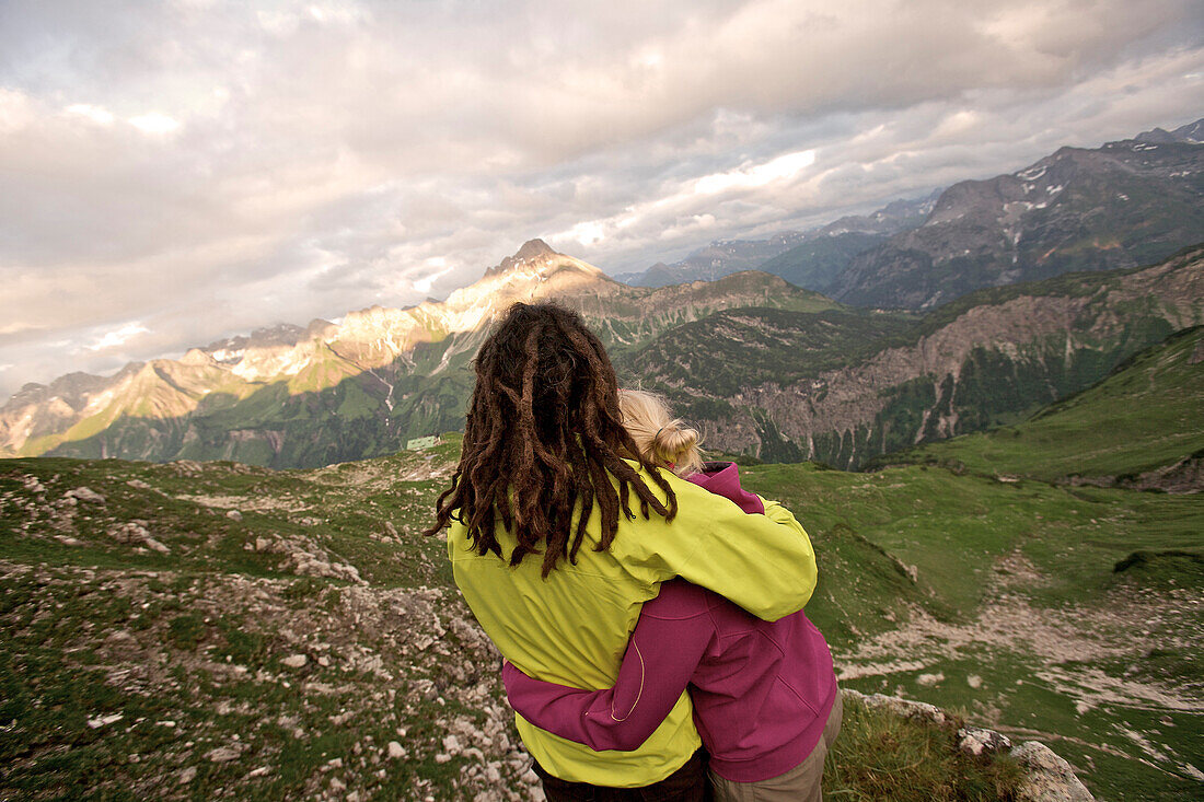 Couple looking to a nice panorama in the mountains, Oberstdorf, Bavaria, Germany