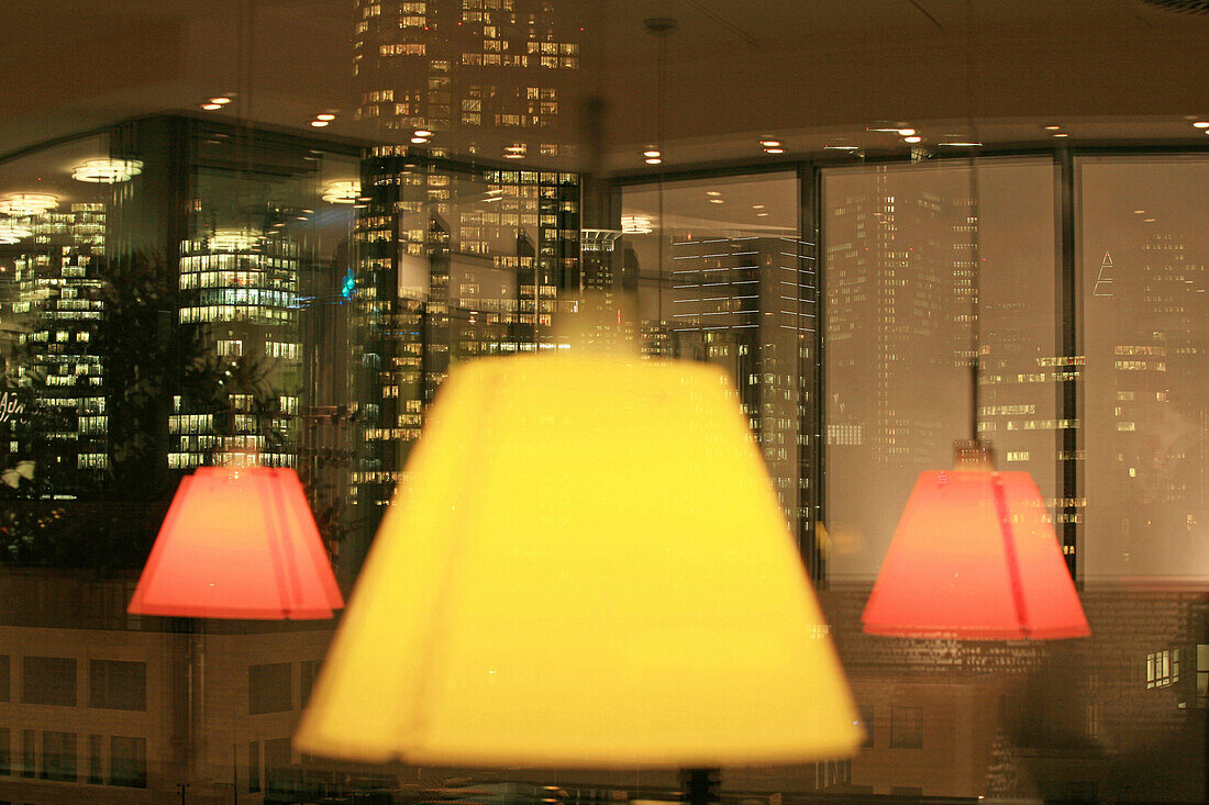 Lamps and skyline reflected in a window, Frankfurt am Main, Hesse, Germany