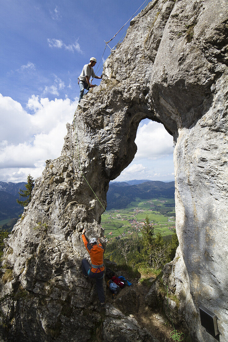 Climbers on a rocky window at Breitenstein moutain near Fischbachau, Wendelstein Mountain Range, Alps, Upper Bavaria, Germany