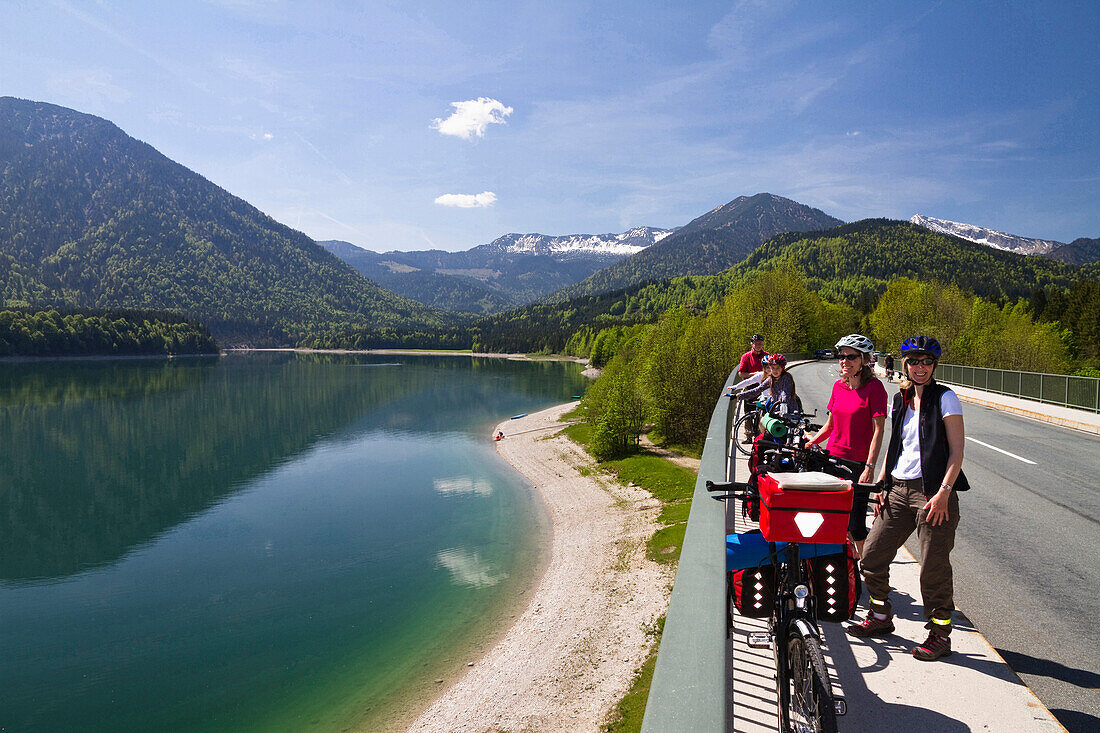 Cyclists resting near Lake Sylvenstein, Isar Cycle Route, Upper Bavaria, Germany