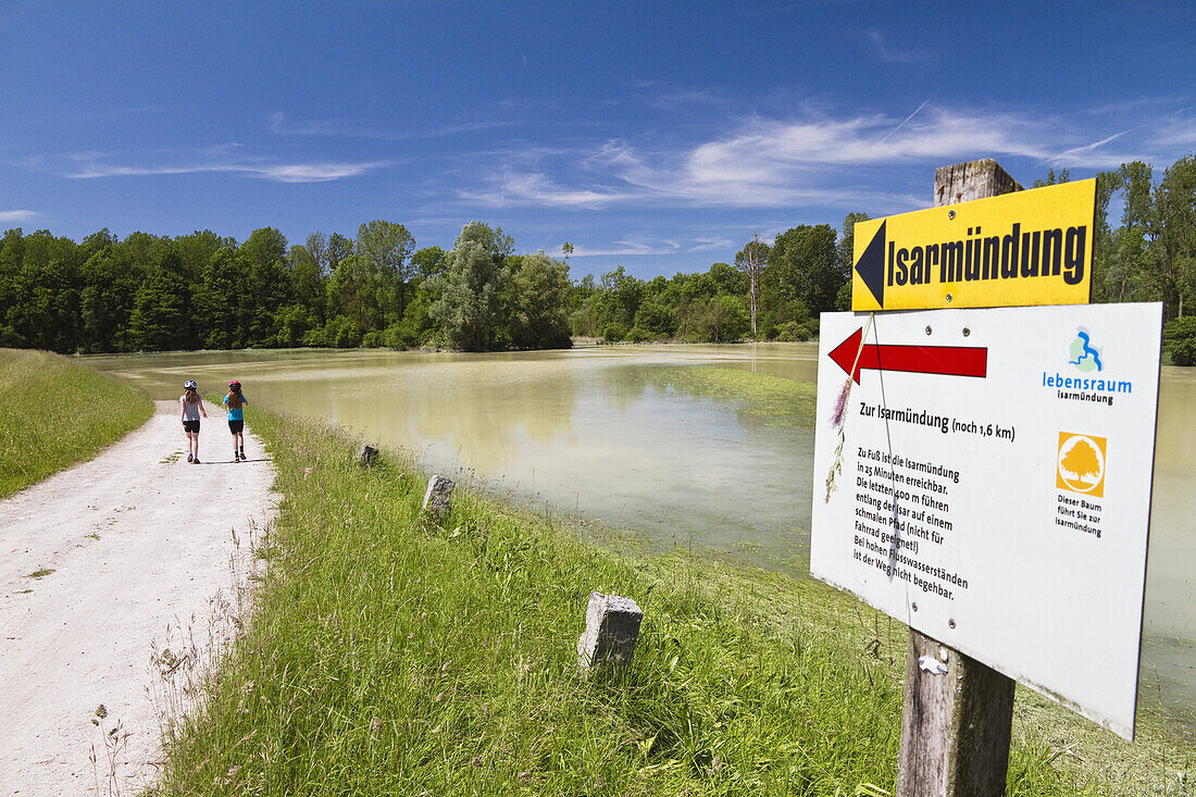 Two girls walking along Isar Cycle Route, Isarmuend, Lower Bavaria, Germany