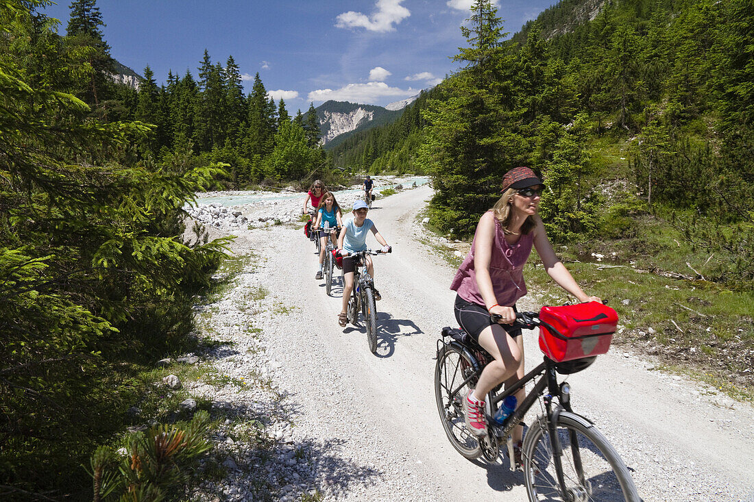 Families cycling along Isar Cycle Route, Hinterau Valley, Karwendel range, Tyrol, Austria