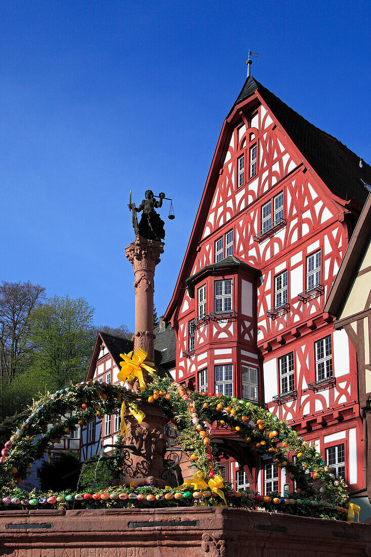 Fountain decorated with Easter eggs at the Schnatterloch, half-timbered houses at the market place, Miltenberg, Main river, Odenwald, Spessart, Franconia, Bavaria, Germany