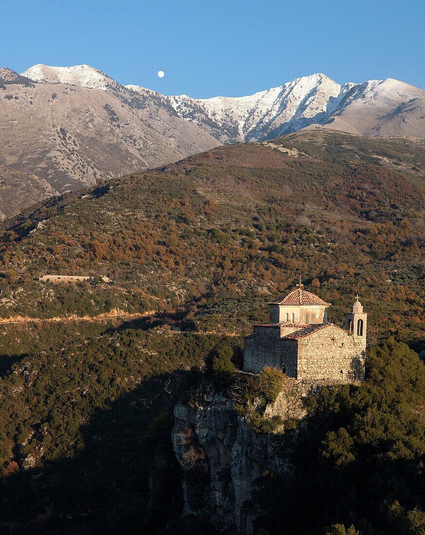 Profitas Ilias monastery above Voiro, one of the Gaitses villages, with the snow covers peak of Halasmeno in the backround, Mani Peninsular, Southern Peloponese, Greece