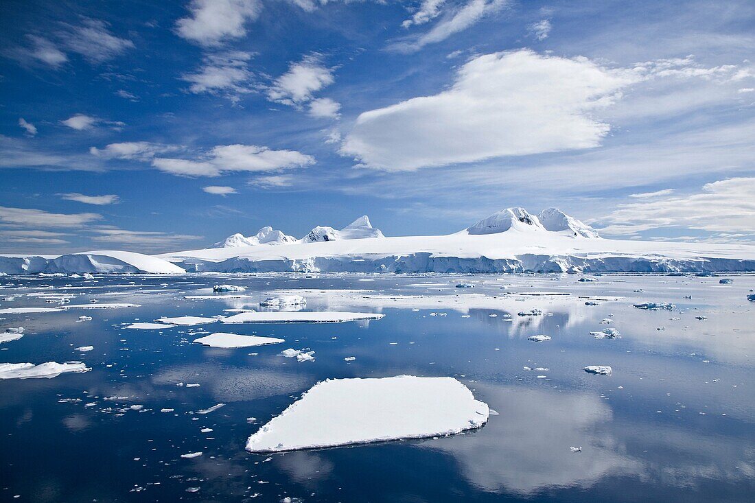 The Lindblad Expeditions ship National Geographic Explorer pushes through ice in Crystal Sound, south of the Antarctic Circle  This area is full of flat first year sea ice, well developed icebergs, with many open leads
