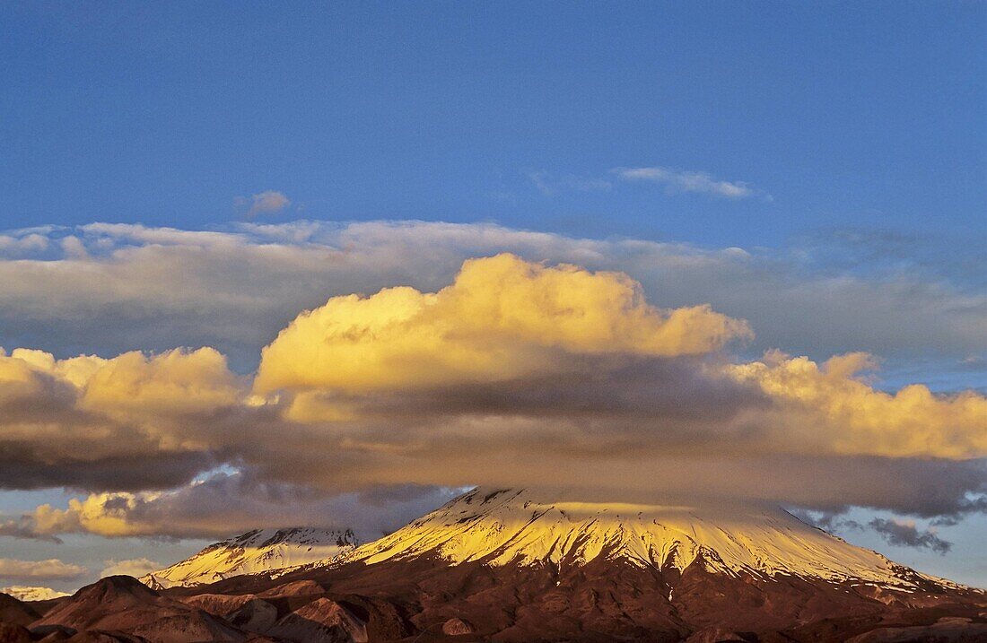 Vulcano Parinacota 6342m and Pomerape 6286m Chile during sunset are part of the Lauca National Park in the Altiplano of northern Chile  Lauca National Park is part of the Biosphere Reserve Lauca, The whole area is shaped by vulcanic processes  America, So