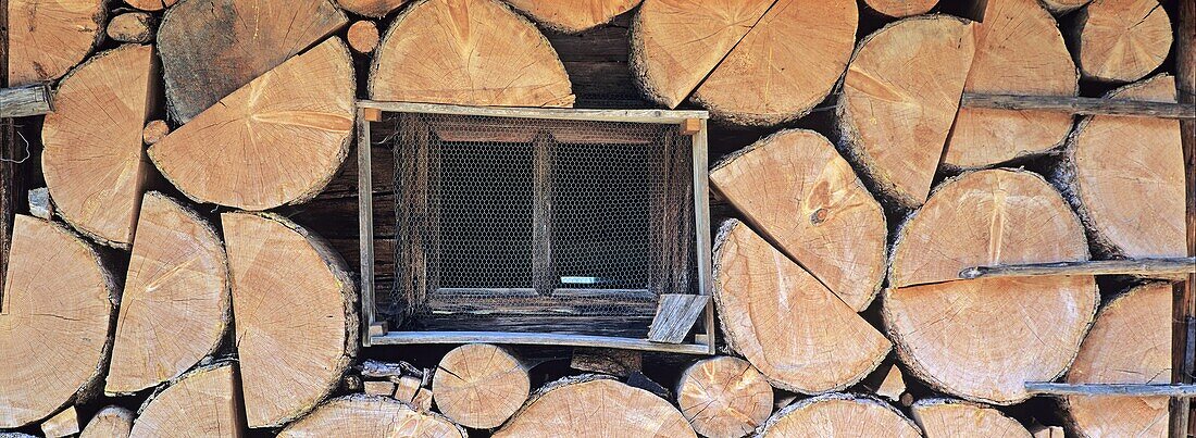 Firewood piled up outside of a bavarian mountain hut     Blaubergalm, Blauberge, Bavaria, Germany, July 2001
