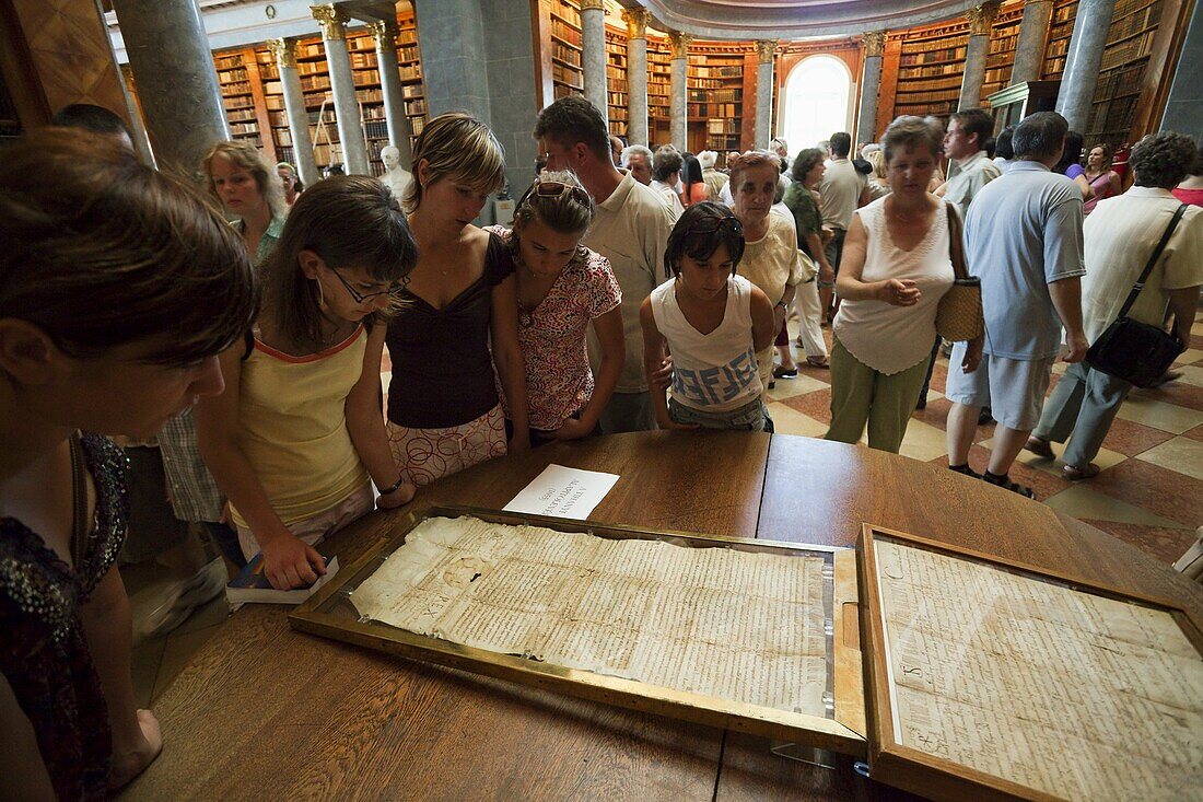 The Archabbey Saint Martin, Pannonhalma, Hungary, is listed as UNESCO world heritage  Library with visitors looking at an old manuscript  Europe, Eastern Europe, Hungary, Pannonhalma, August 2009